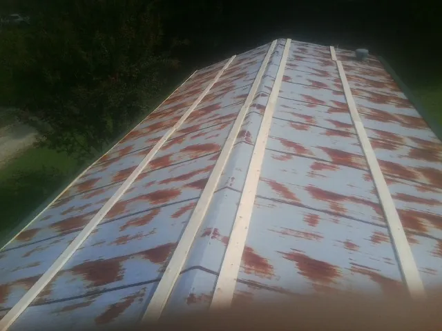 Rusted metal roof panels with new wood purlins before replacement — Storm Damage Roof Repair in Greenville by Roofing Brothers